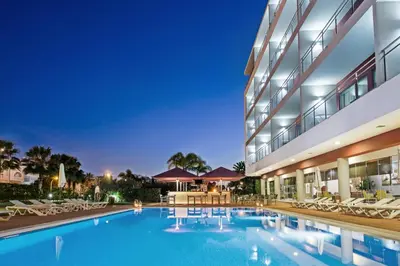 a rendering of a hotel at night at Areias Village Beach Suite Hotel in Albufeira