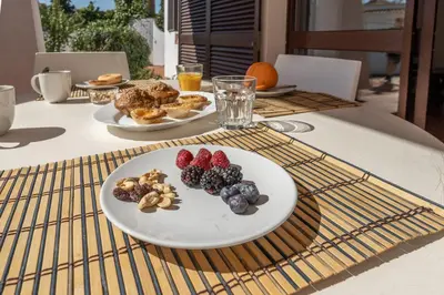 a table with two plates of food on it at Casa das Anas by HelloVacations in Albufeira