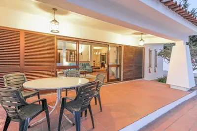 a patio with a table and chairs on it at Casa das Anas by HelloVacations in Albufeira