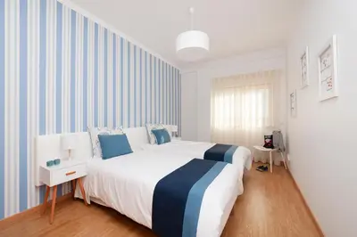 a table with a bottle of champagne and two glasses at Apartamento Oura - BlueSea in Albufeira
