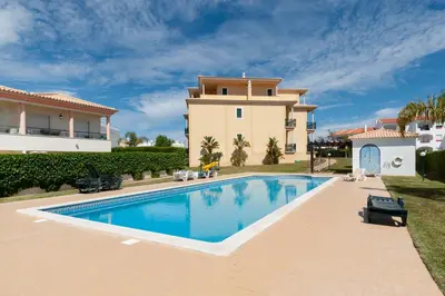 a villa with a swimming pool in a yard at Apartamento Oura - BlueSea in Albufeira