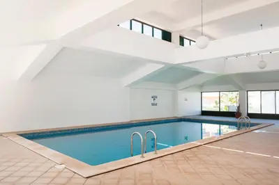 a swimming pool in a house with a ceiling at Santa Eulália Apartment Luxury - Blue Sea in Albufeira
