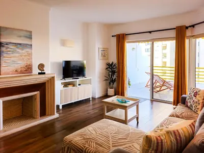 a living room with a couch and a fireplace at FLH Vilamoura Sunny Apartment with Pool in Vilamoura