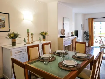 a dining room with a table and some chairs at FLH Vilamoura Sunny Apartment with Pool in Vilamoura