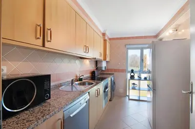 a kitchen with a sink and a refrigerator at PALM PARADISE SALGADOS in Albufeira