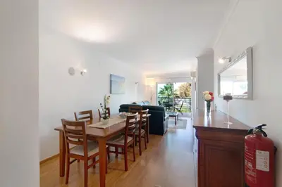 a kitchen and living room with a table and chairs at PALM PARADISE SALGADOS in Albufeira