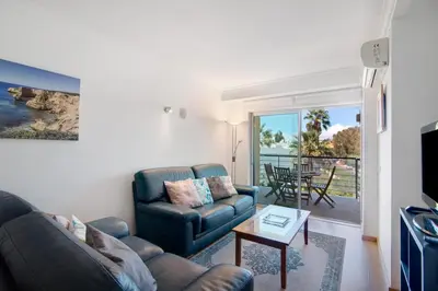 a living room with a couch and a table at PALM PARADISE SALGADOS in Albufeira