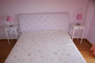 a bedroom with a large bed with two night stands at Apartamento Felicidade in Almancil