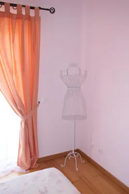 a mannequin in a bedroom with a dresser next to a window at Apartamento Felicidade in Almancil