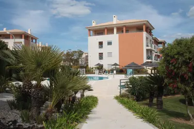 a resort with a swimming pool and a building at Apartamento com Piscina em Albufeira, Corcovada in Albufeira