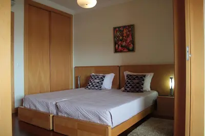 a bedroom with a bed with two pillows on it at Apartamento com Piscina em Albufeira, Corcovada in Albufeira