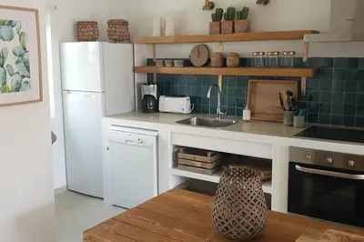 a kitchen with a white refrigerator and a sink at Old Village Design 3 Bedroom Townhouse in Vilamoura