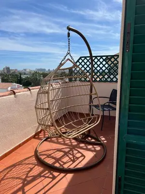 a shopping basket is hanging on a balcony at Old Village Design 3 Bedroom Townhouse in Vilamoura