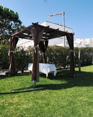 a table under a canopy in the grass at Natura Algarve Club in Albufeira