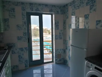 a kitchen with a refrigerator and a window at AMM SeaView Marina Albufeira apartment in Albufeira