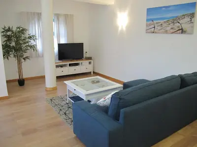 a living room with a blue couch and a tv at AMM SeaView Marina Albufeira apartment in Albufeira