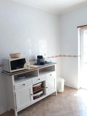 a kitchen with a microwave on top of a cabinet at AMM Albufeira Nice Hollydays apartment in Albufeira