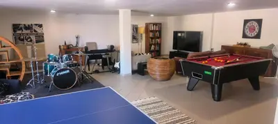 a living room with a pool table and music equipment at Casa da Colina in Loulé