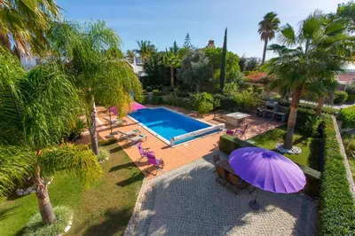an overhead view of a pool with a purple umbrella at Casa da Colina in Loulé