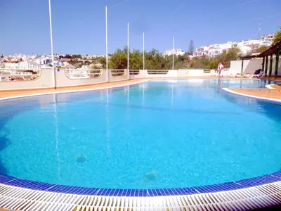 a large swimming pool with blue water at Varandas do Mar by Sunny Deluxe in Albufeira