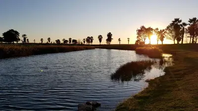 a river with the sun setting in the background at Magnific Studio with a cozy garden, 5 minutes to the beach in Albufeira