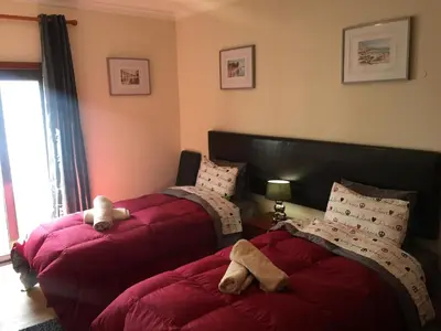 a bedroom with two beds with stuffed animals on them at Apt 2 Quartos, BBQ, AC, Terraço, Prestige For Home in Quarteira