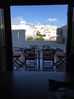 a table and chairs on a balcony with a view at Apt 2 Quartos, BBQ, AC, Terraço, Prestige For Home in Quarteira