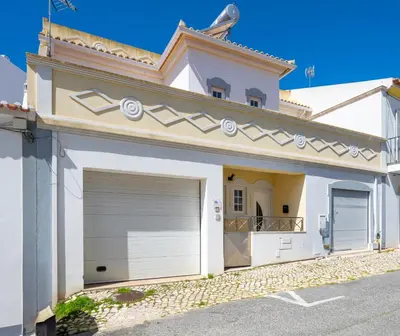 a white house with a garage at Full private 180sqm Villa - Terrace Jacuzzi - 200m Beach & Sea View in Albufeira