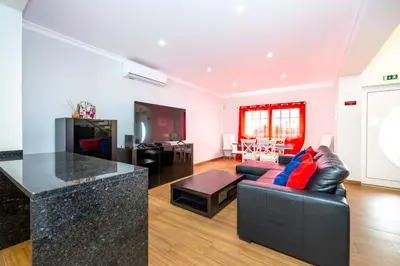 a living room with a couch and a table at Full private 180sqm Villa - Terrace Jacuzzi - 200m Beach & Sea View in Albufeira