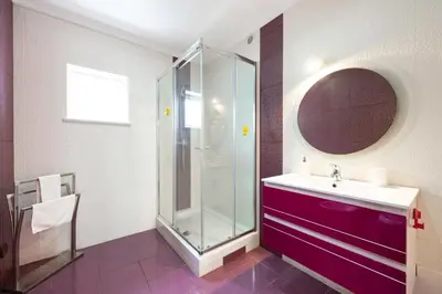 a bathroom with a glass shower and a sink at Full private 180sqm Villa - Terrace Jacuzzi - 200m Beach & Sea View in Albufeira
