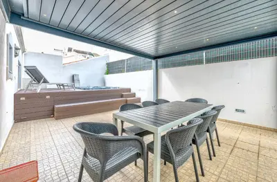 a dining room with a table and chairs at Full private 180sqm Villa - Terrace Jacuzzi - 200m Beach & Sea View in Albufeira
