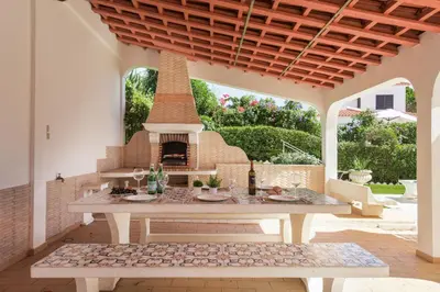 a backyard with a swimming pool and a house at A Fantastic Place for Families, Hilton Hotel are and close to amenities in Quarteira