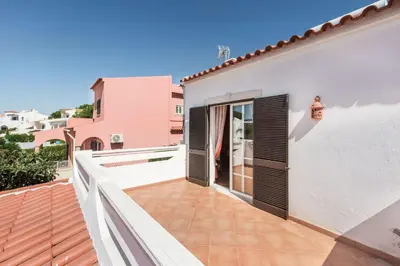 a patio with a brick fireplace on a patio at A Fantastic Place for Families, Hilton Hotel are and close to amenities in Quarteira