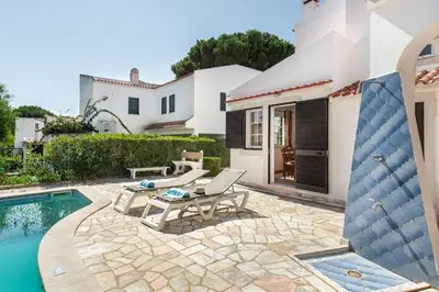 a villa with a swimming pool and a house at A Fantastic Place for Families, Hilton Hotel are and close to amenities in Quarteira