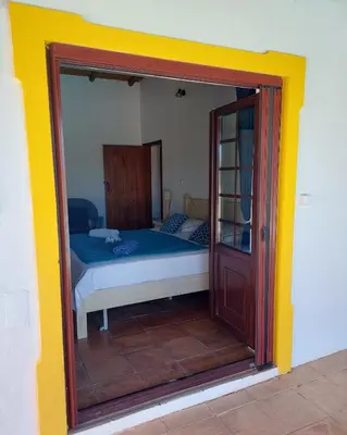 a bedroom with a bed and a sliding glass door at La Quinta casa com piscina privada in Loulé