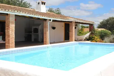 a swimming pool in front of a house at La Quinta casa com piscina privada in Loulé