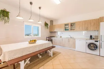 a kitchen with a table and a sink and a dishwasher at Villa Rita in Silves