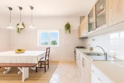 a kitchen with a table and a sink at Villa Rita in Silves