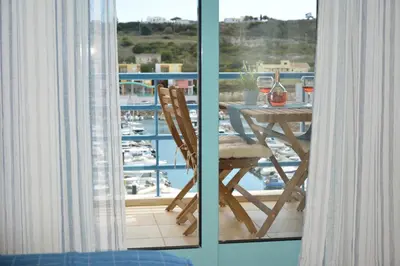 a balcony with a table and a view of a marina at Stunning Apartment with Marina Views in Albufeira
