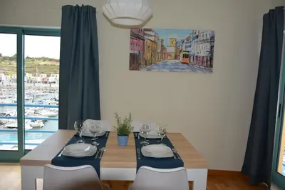 a dining room with a table with wine glasses on it at Stunning Apartment with Marina Views in Albufeira