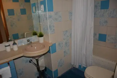 a bathroom with a sink and a toilet and a shower at Stunning Apartment with Marina Views in Albufeira