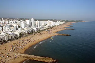 an aerial view of a beach with a crowd of people at Irene's Place in Quarteira