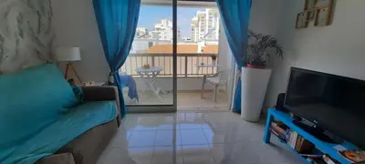a living room with a couch and a flat screen tv at Irene's Place in Quarteira