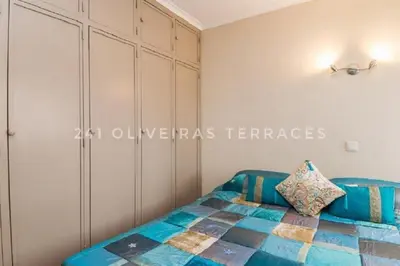 a bedroom with a blue bed and a cabinet at 241 Oliveiras Terraces in Albufeira