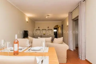 a living room with a table and a couch at 241 Oliveiras Terraces in Albufeira
