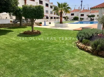 a villa with a pool and a yard at 241 Oliveiras Terraces in Albufeira