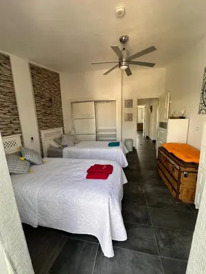 a bedroom with two beds and a ceiling fan at Apartamentos Sao Rafael, 80b in Albufeira