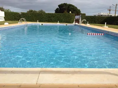 a large swimming pool with blue water at Solgarve in Quarteira