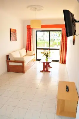 a living room with a couch and a table at Solgarve in Quarteira