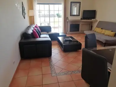 a living room with a couch and a table at Beautiful Vila Rafaella, walk distance to beaches in Albufeira